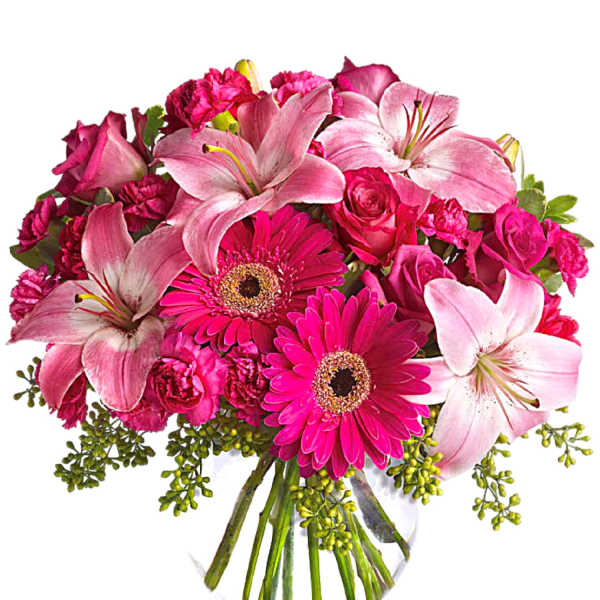 Pink lilies, roses, and gerbera daisies in a clear glass vase