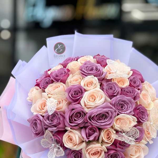 Bouquet of lavender and blush roses wrapped in pastel paper