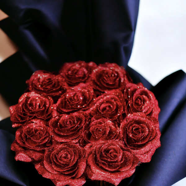 Round bouquet of glittery red roses wrapped in black paper