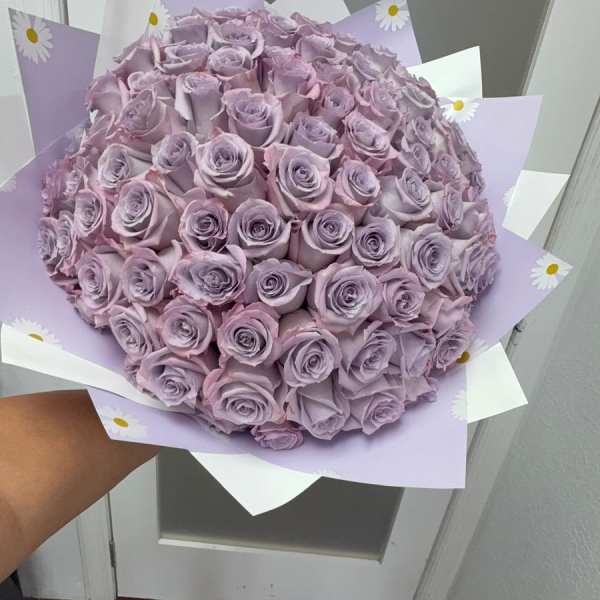 Large bouquet of lavender roses wrapped in pastel paper