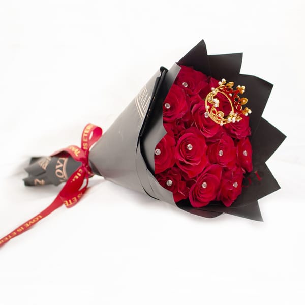 Bouquet of red roses wrapped in black paper with a red ribbon