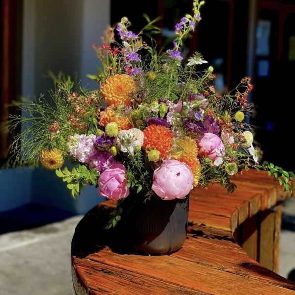 Colorful mixed bouquet in a dark vase