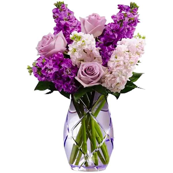 Lavender roses and purple flowers in a cut-glass vase