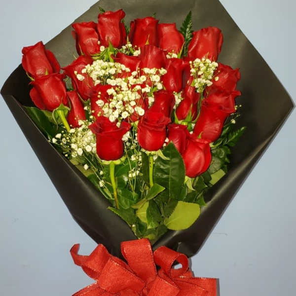 Bouquet of red roses with white baby's breath and a red ribbon