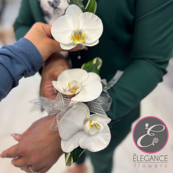 White orchid corsage with silver ribbon accents