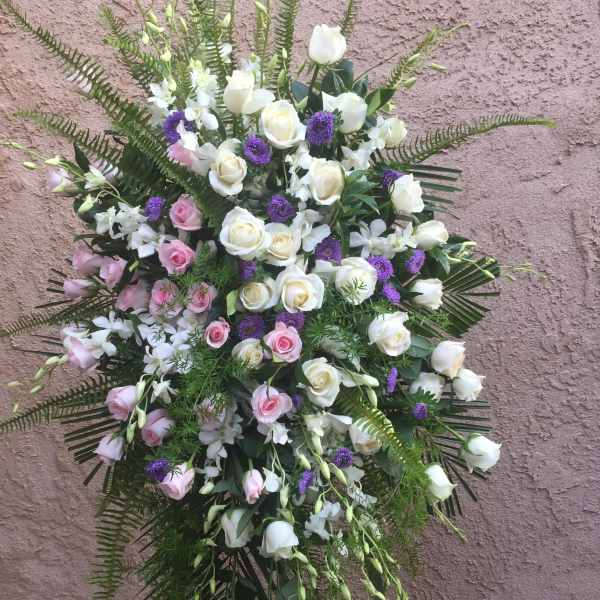 Standing floral spray with white and pink roses and purple accents
