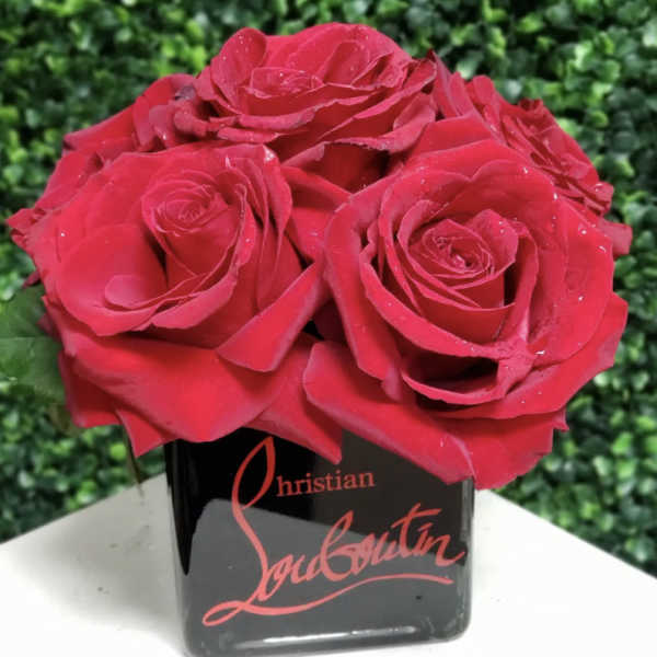 Red roses arranged in a black square vase