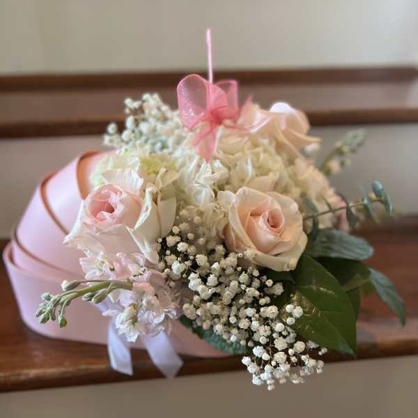 Pink and white rose bouquet with baby's breath and ribbon