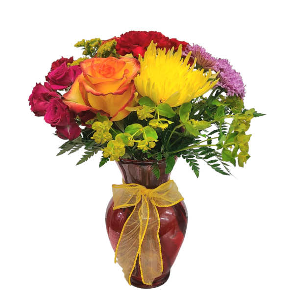 Mixed bouquet of roses and chrysanthemums in a red glass vase with a yellow ribbon