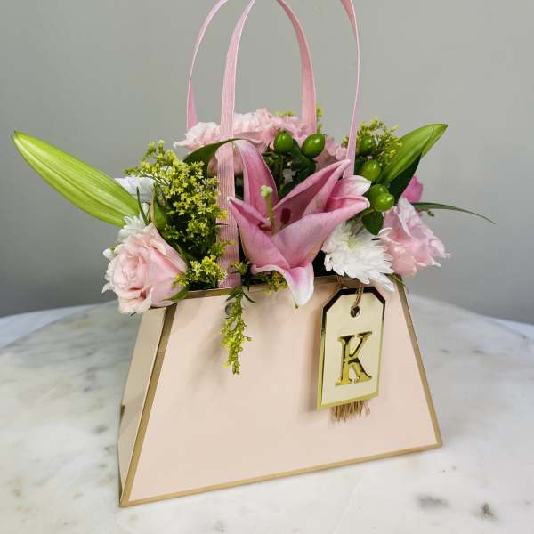 Pink floral gift bag with lilies and roses