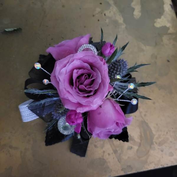 Small purple rose corsage with black ribbon and sparkly accents