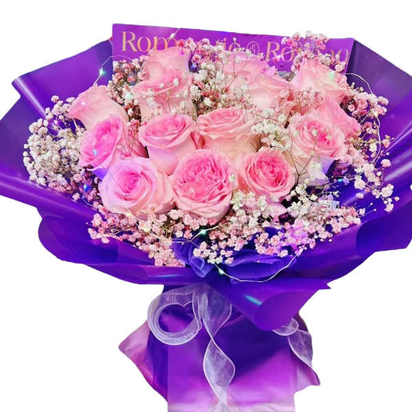 Pink roses and baby's breath wrapped in purple paper