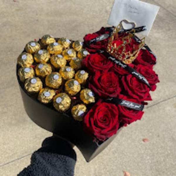 Heart-shaped box with red roses and gold-wrapped chocolates