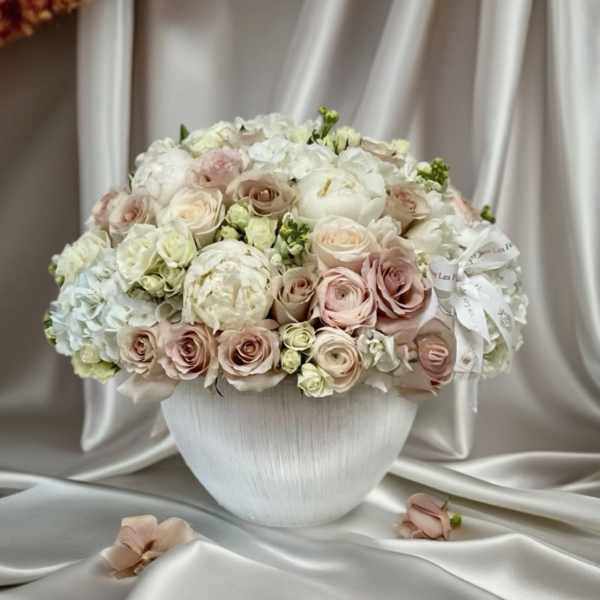 Blush and white rose bouquet in a white vase