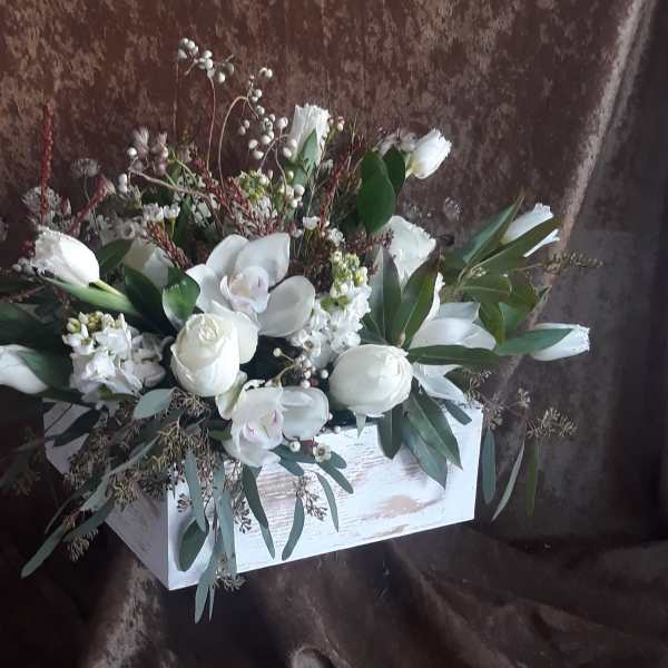 White floral arrangement in a rustic white wooden box