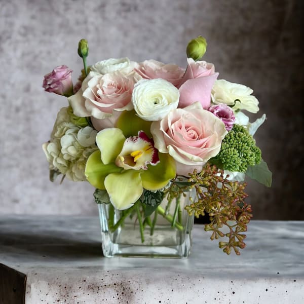 Pink and white bouquet in a clear glass vase