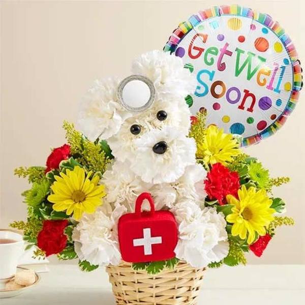 White teddy bear flower arrangement with a Get Well Soon balloon