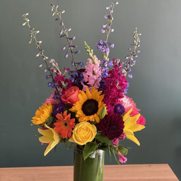 Colorful mixed bouquet in a tall glass vase