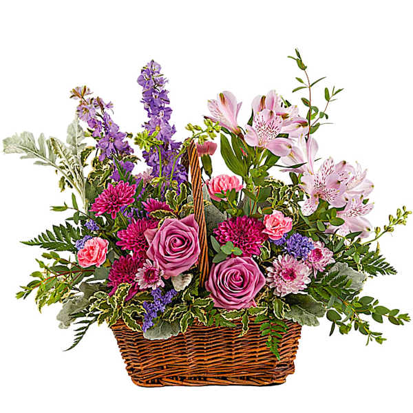 Mixed pink and purple flowers in a wicker basket