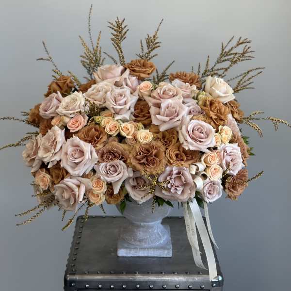 Large bouquet of blush and tan roses in a gray vase