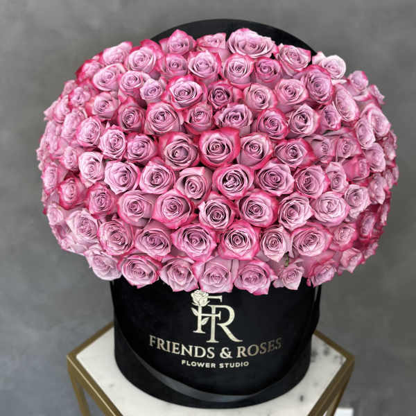 Round box filled with pink roses