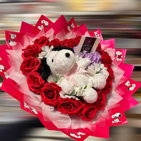 Bouquet of red roses with a Snoopy plush toy and pink wrapping