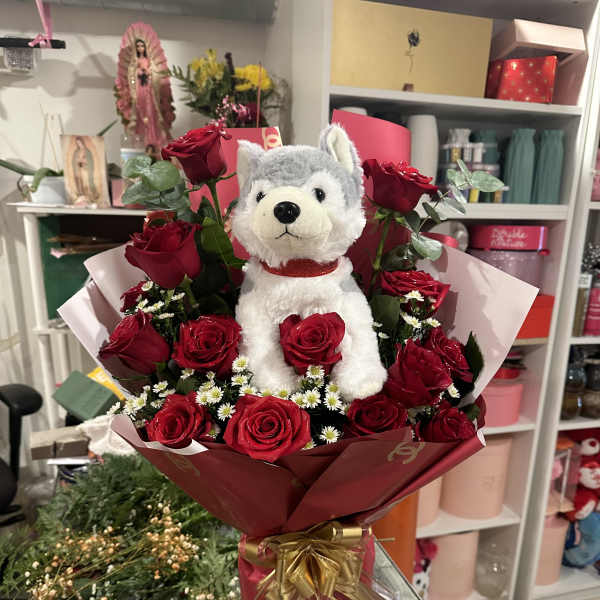 Bouquet of red roses with a plush wolf in the center