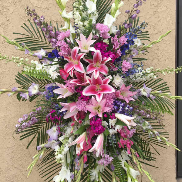 Large standing floral spray with pink lilies and purple-white flowers