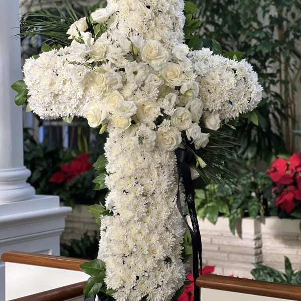 White floral cross arrangement with roses and chrysanthemums