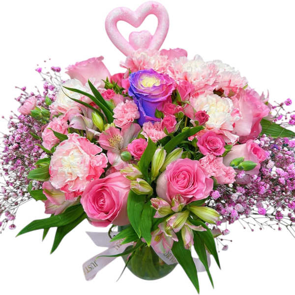 Pink and white bouquet with roses and carnations in a glass vase