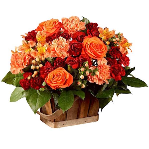Orange and red flower arrangement in a wooden basket