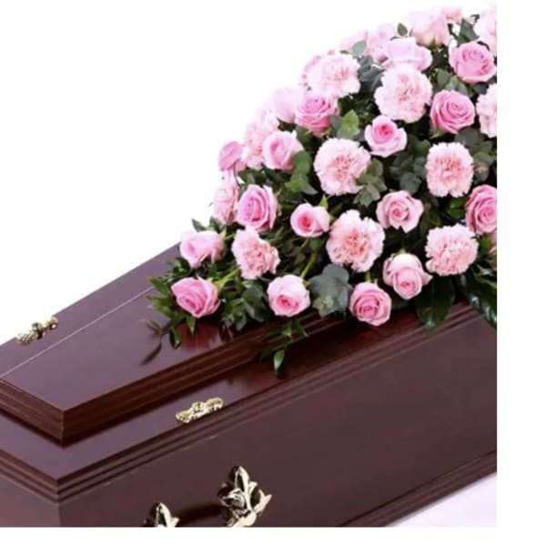 Pink roses and carnations arranged on a casket