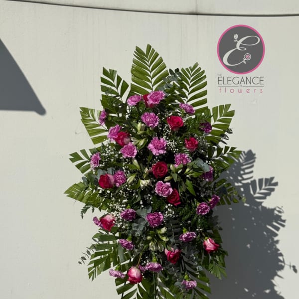 Standing floral spray with pink roses and purple carnations
