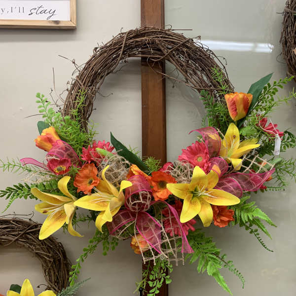 Colorful floral wreath with yellow lilies and orange-pink flowers