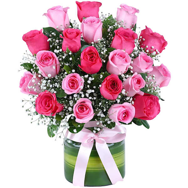 Pink and hot pink roses in a green glass vase with a pink ribbon