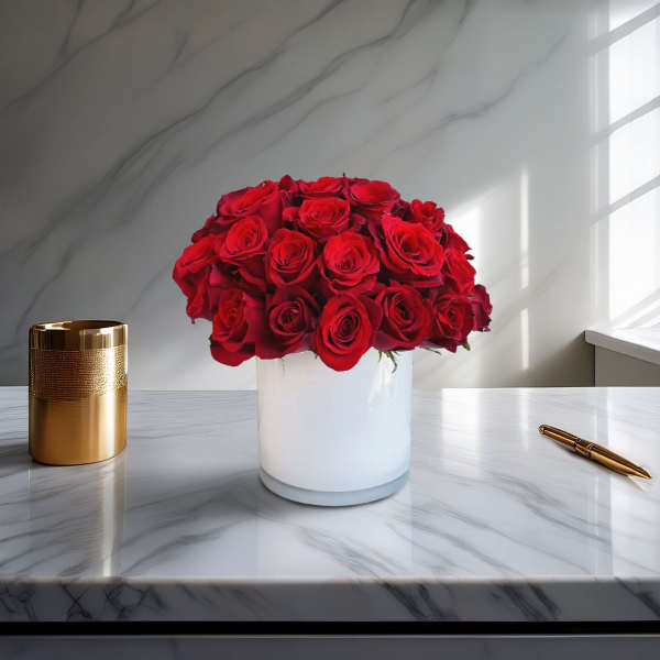 Red rose bouquet in a white vase on a marble table