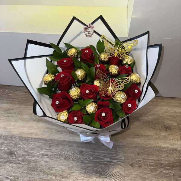 Bouquet of red roses and gold-wrapped chocolates with butterfly picks