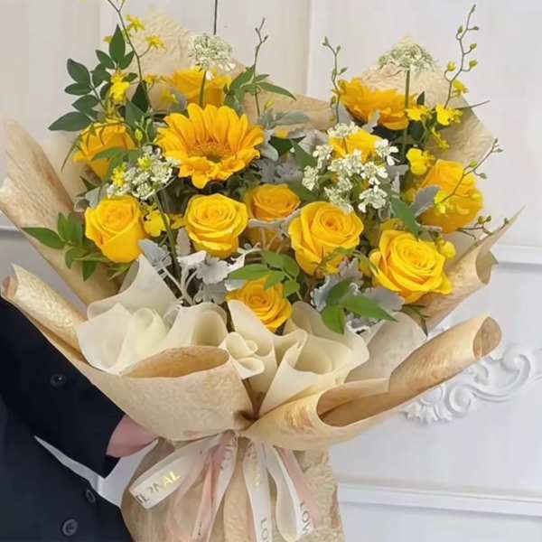 Bouquet of yellow roses and a sunflower wrapped in beige paper