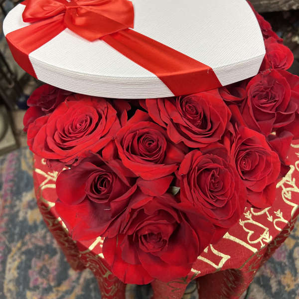 Heart-shaped box of red roses with a red ribbon and bow