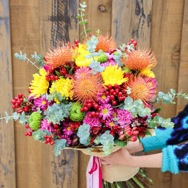 Bright mixed bouquet with yellow, pink, and orange flowers