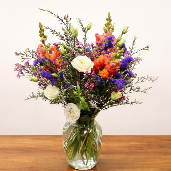 Colorful mixed bouquet in a clear glass vase