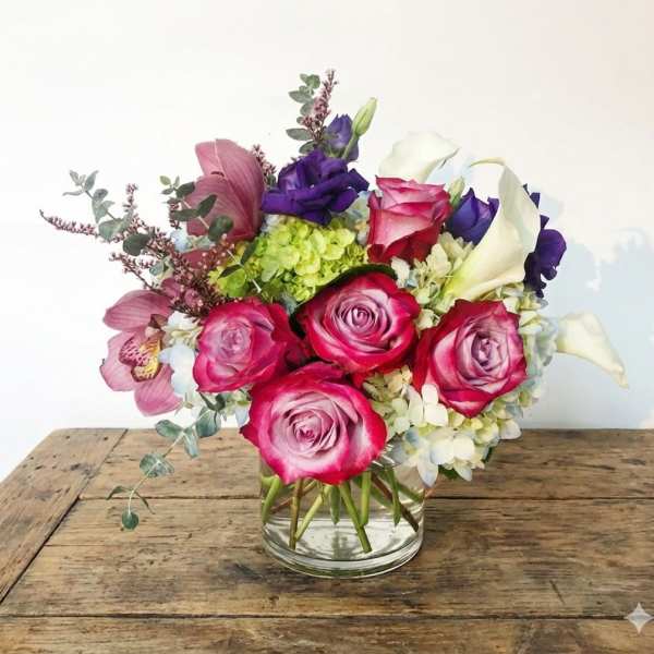 Pink roses and white calla lilies in a glass vase