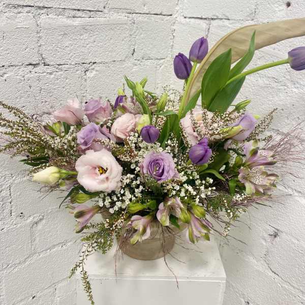 Lavender and pink bouquet in a beige vase