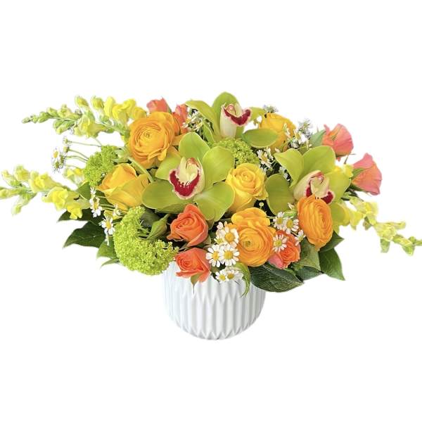 Bright mixed bouquet in a white vase with orange, yellow, and green flowers