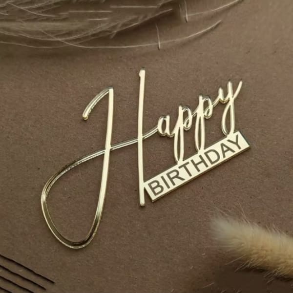 Gold "Happy Birthday" topper on brown background