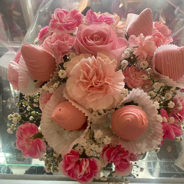 Pink bouquet with roses, carnations, and small white filler flowers