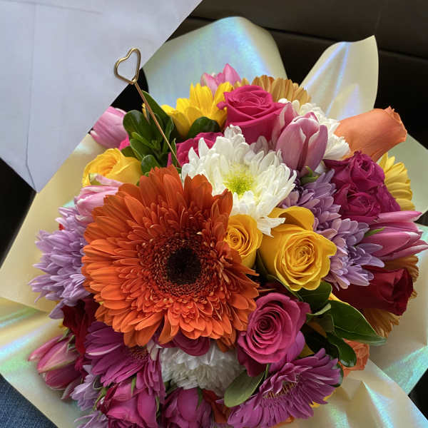 Bright mixed bouquet with roses, gerbera daisies, tulips, and chrysanthemums