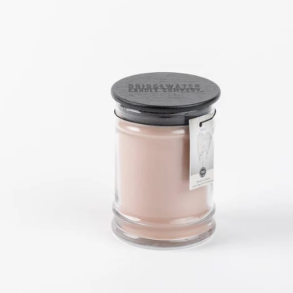 Pink candle in a glass jar with a black lid