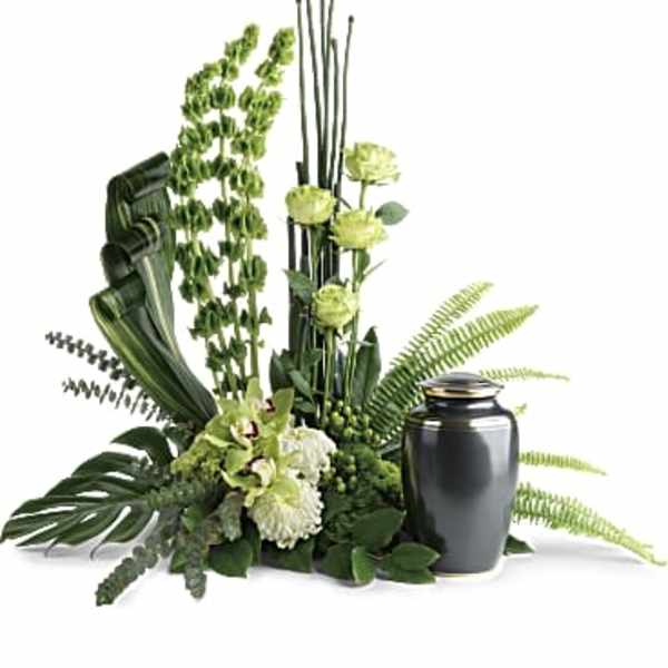 Green floral arrangement with a dark urn vase