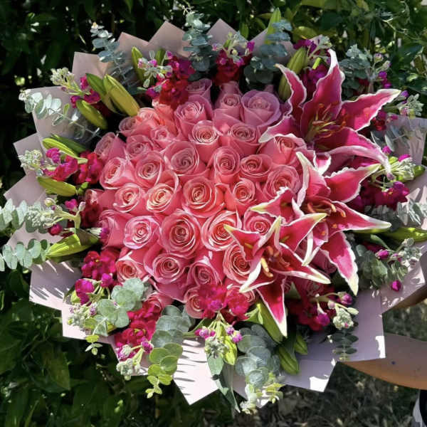 Pink rose bouquet with magenta lilies and eucalyptus